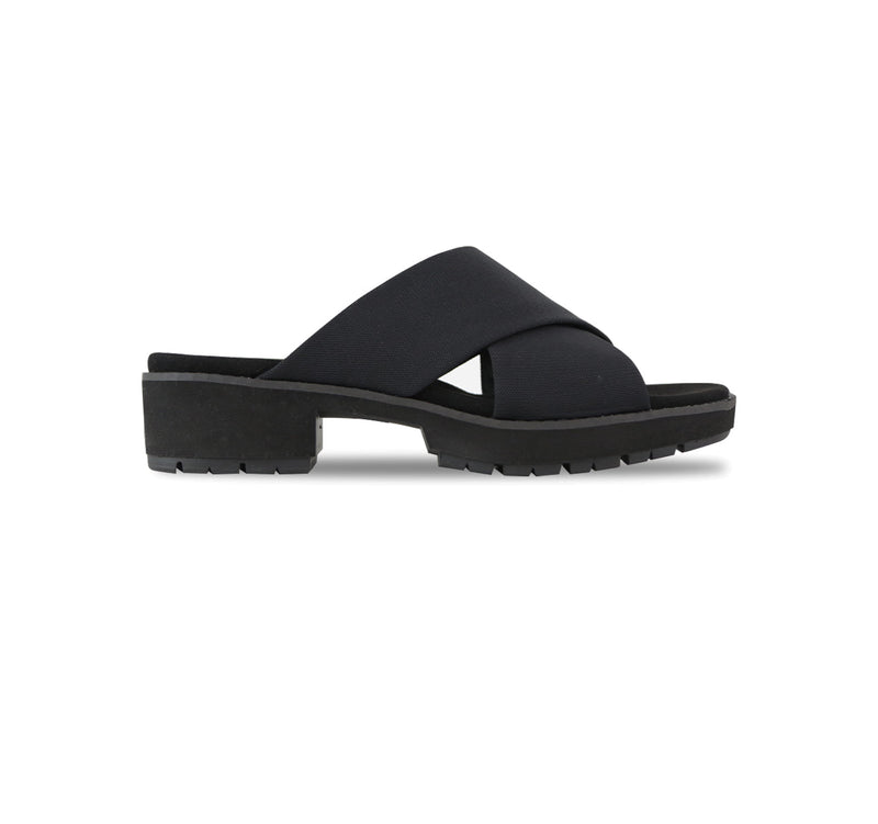 Dekkie slide sandal with wide black fabric bands crisscross the instep to support and comfort your feet-side view