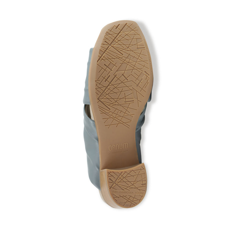 Lee ruched cross-band slide sandal on mid-height Leawood stacked heel in blue ultra-supple lamb leather-bottom view